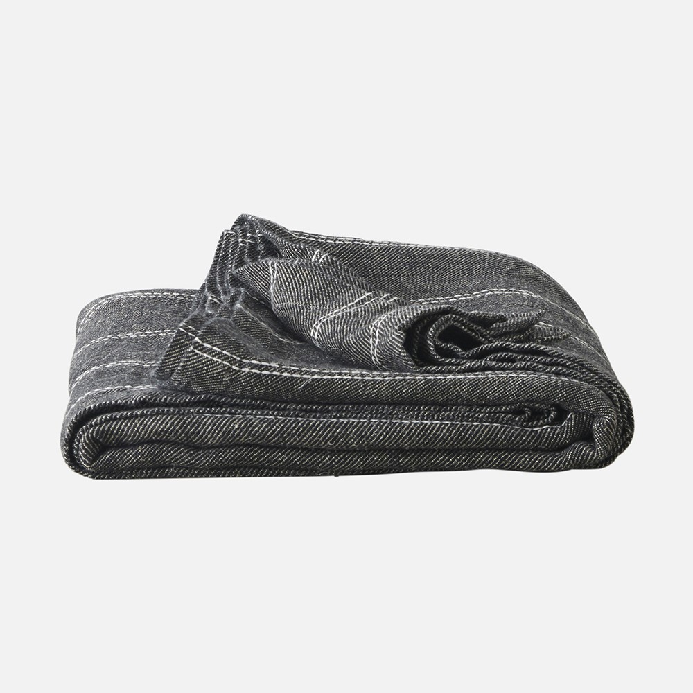 a folded black and white blanket on a white background