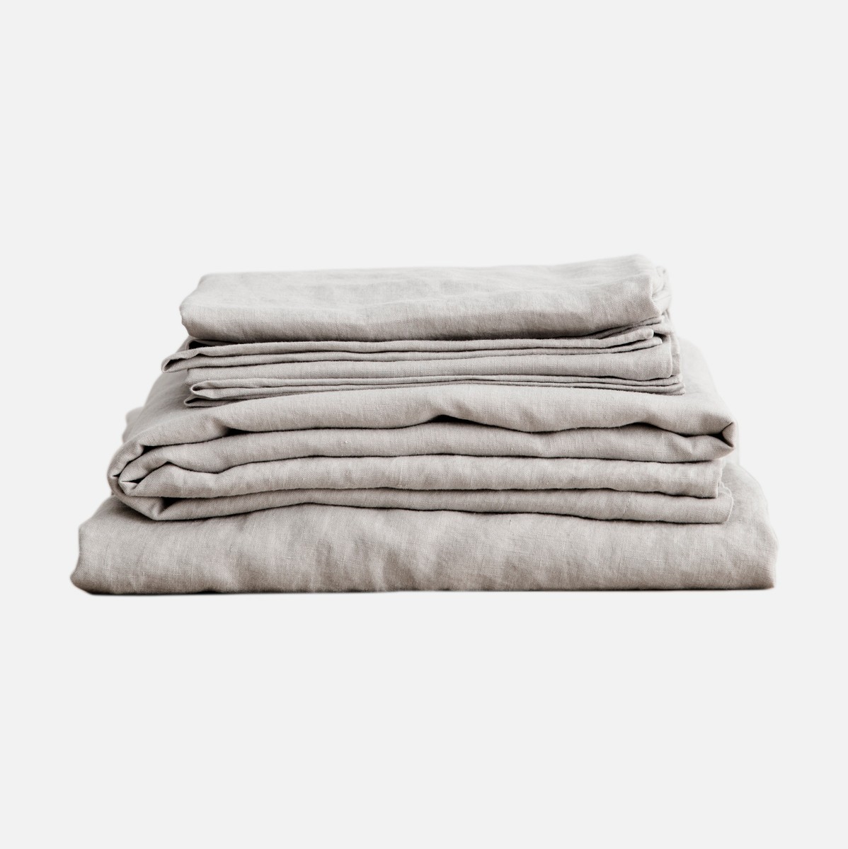 a stack of linen sheets folded on top of each other