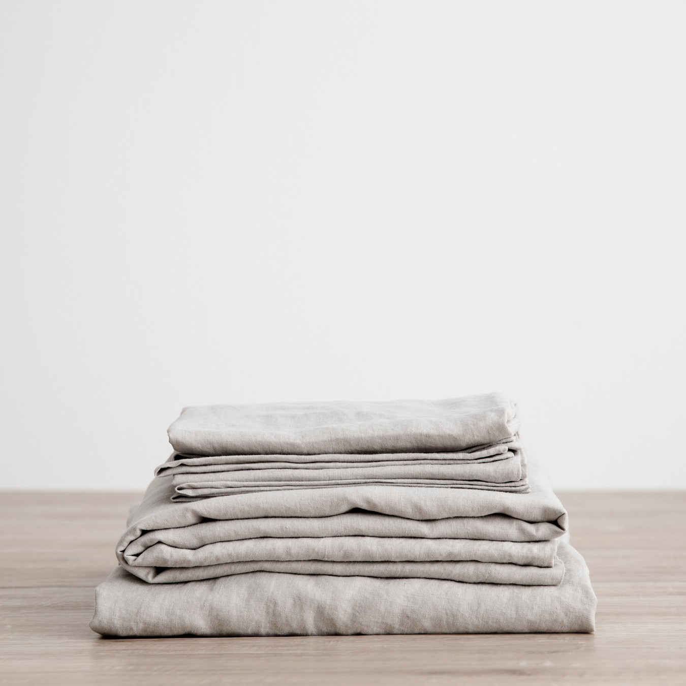 a stack of folded linens on a wooden table
