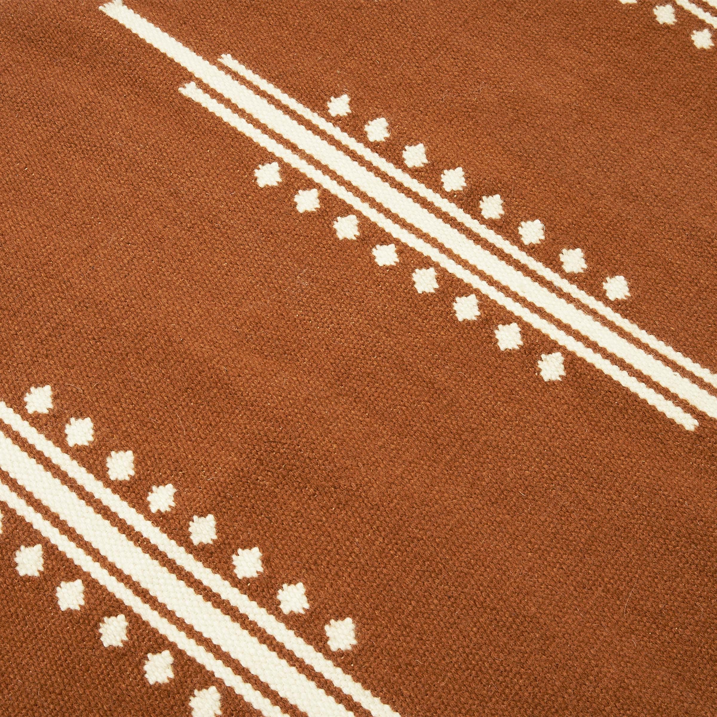 a close up of a brown and white rug