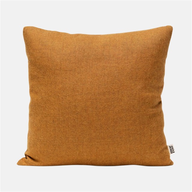 a brown pillow on a white background
