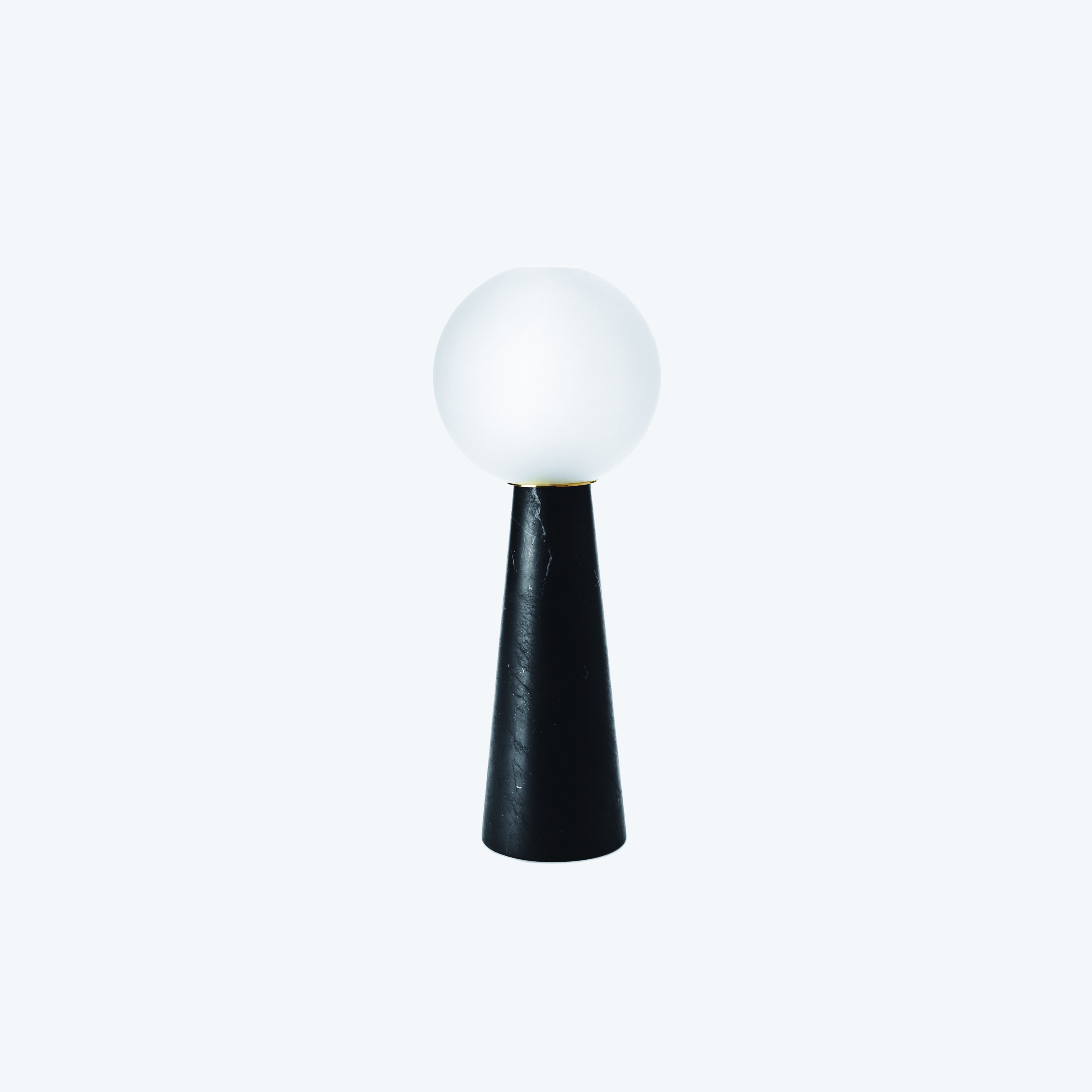 a white light sitting on top of a black stand
