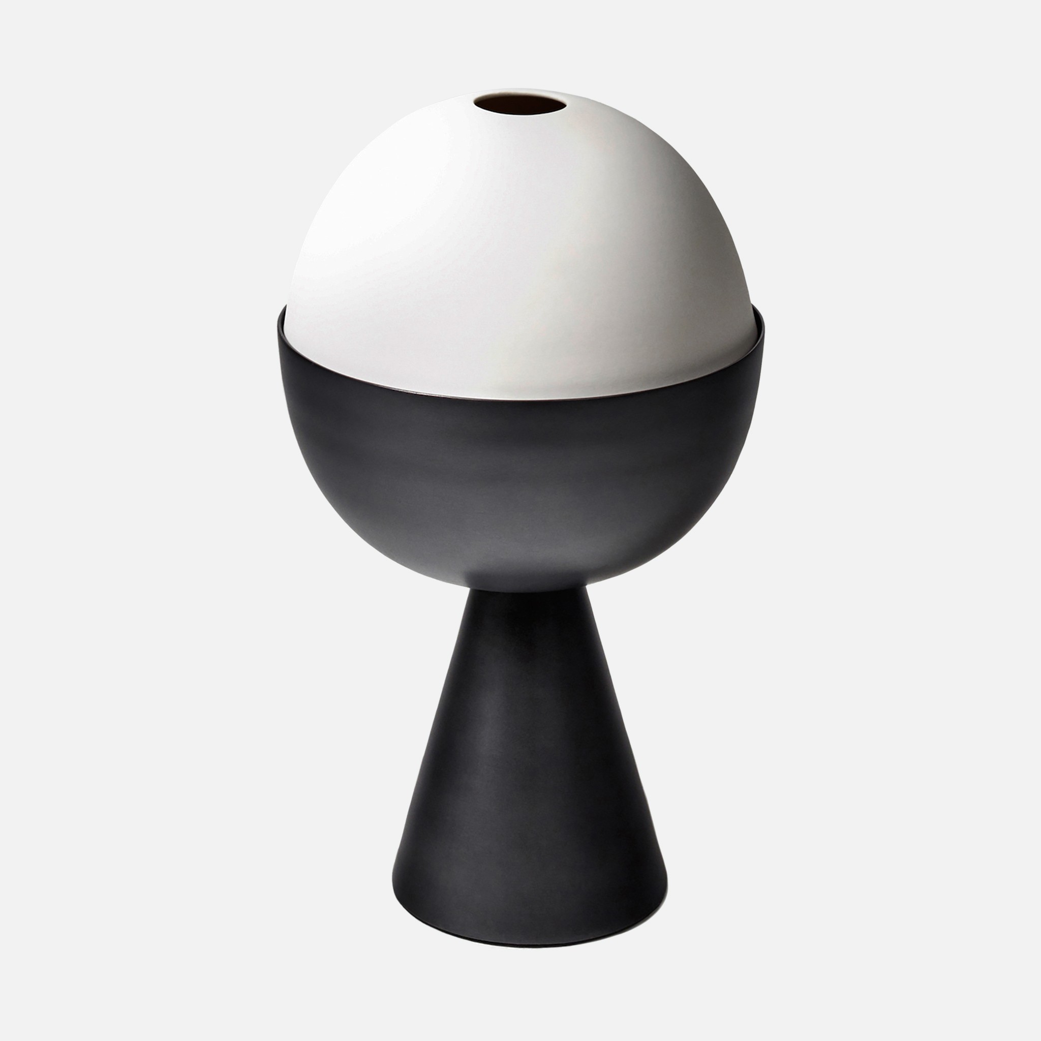 a black and white vase sitting on top of a table