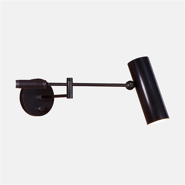 a black wall light on a white background