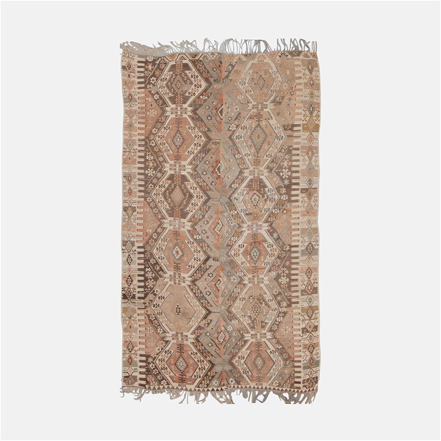 a beige and brown rug with fringes