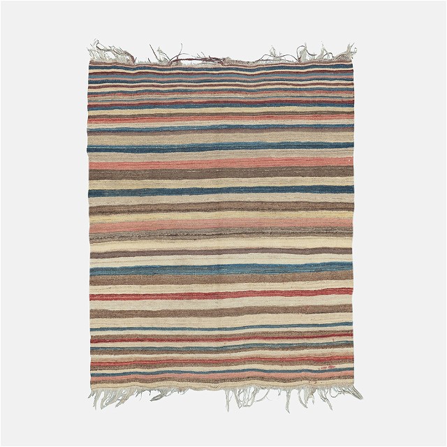 a multicolored striped rug with fringes