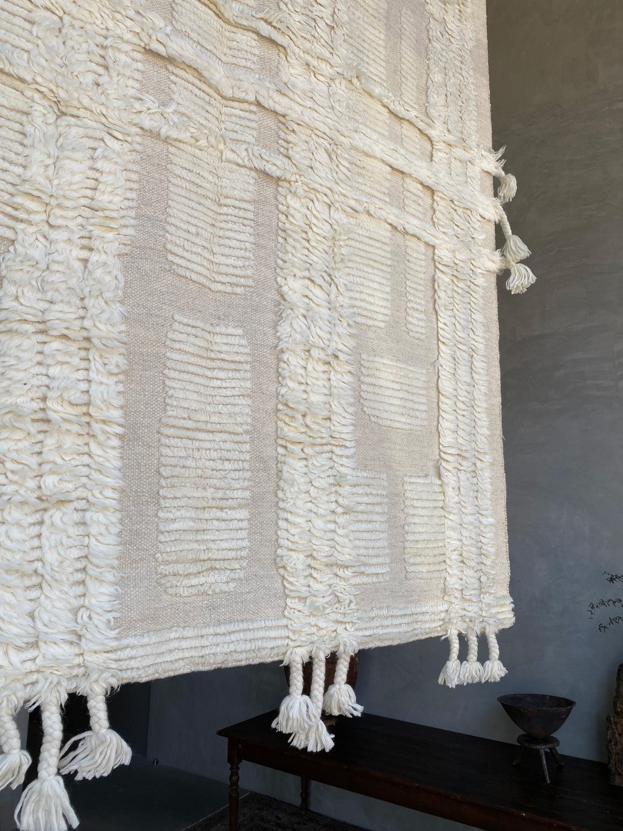 a white blanket hanging from the side of a wall