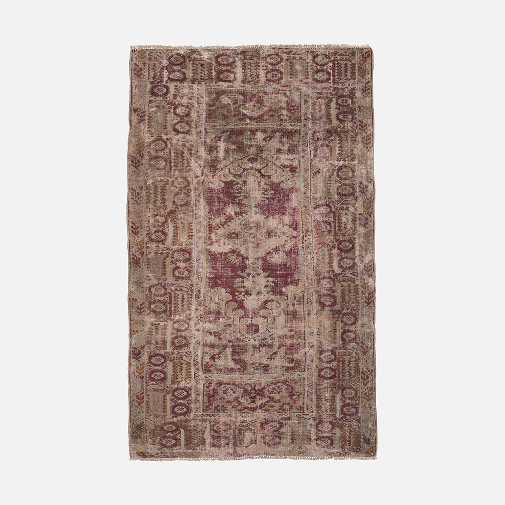 a rug with a red and beige design on it