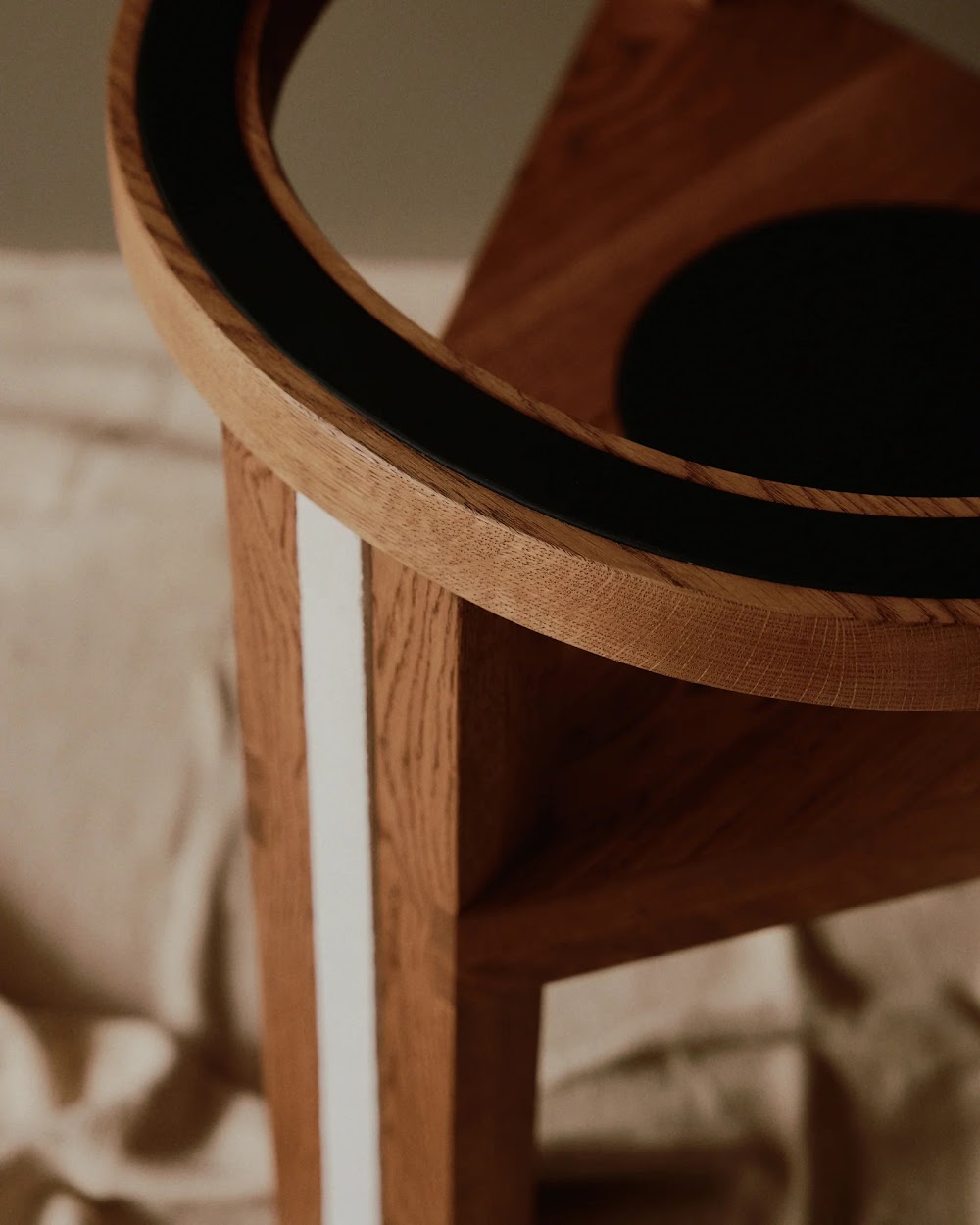 a close up of a wooden chair with a curved seat