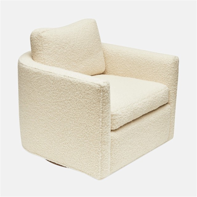 a white chair with a pillow on top of it