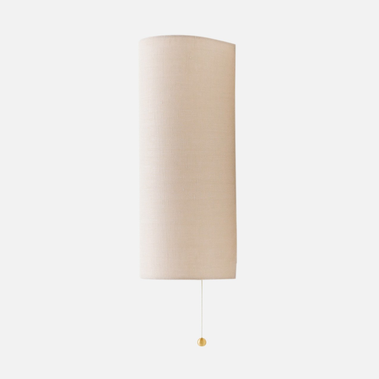 a lamp that is on a white wall