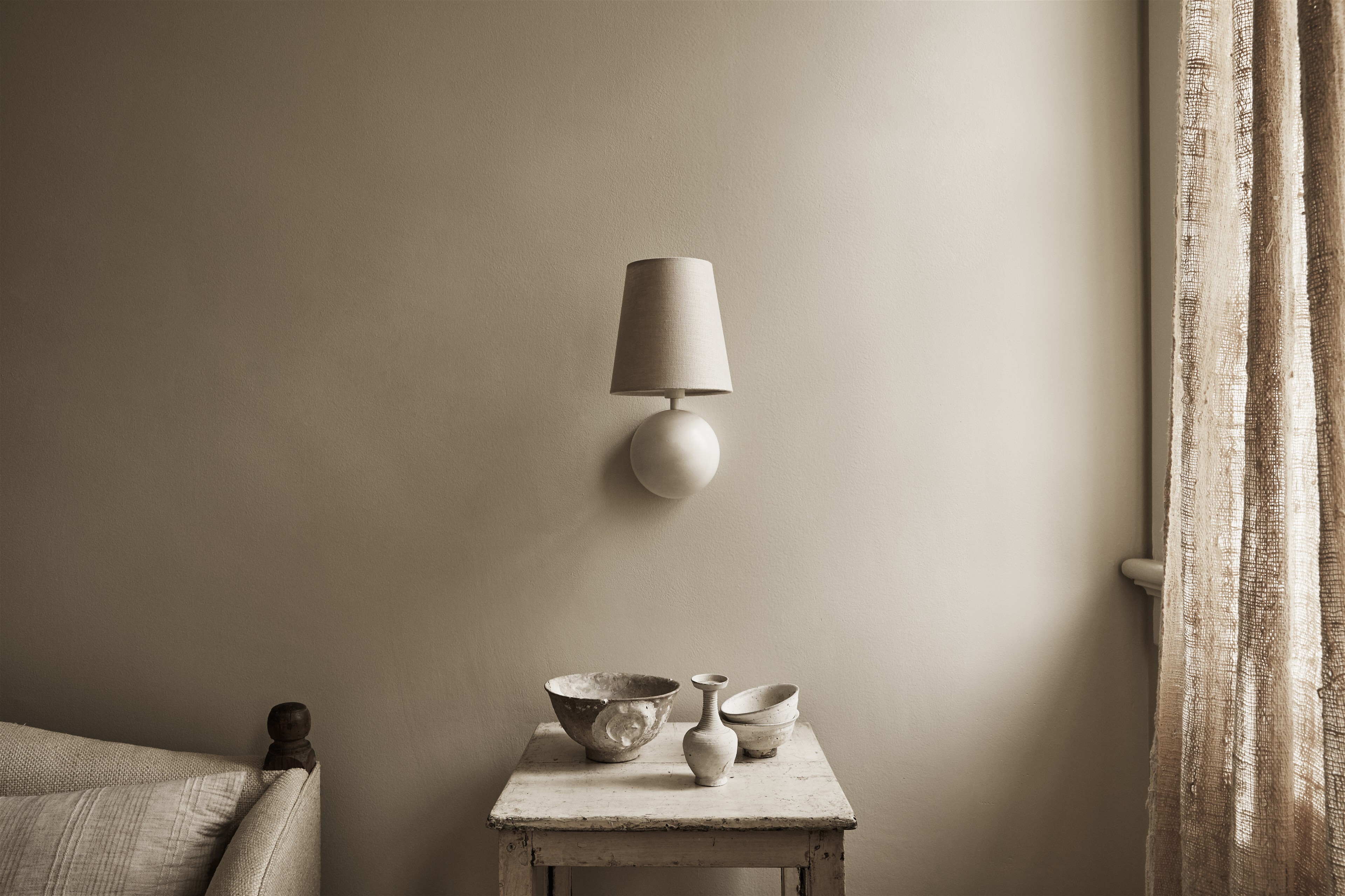 a table with bowls on it next to a lamp