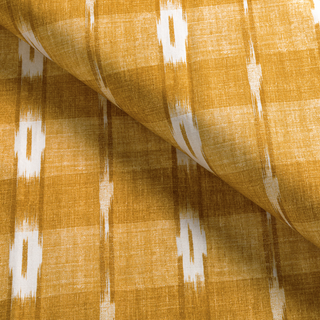 a close up of a yellow and white fabric