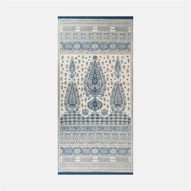 a blue and white rug with a design on it